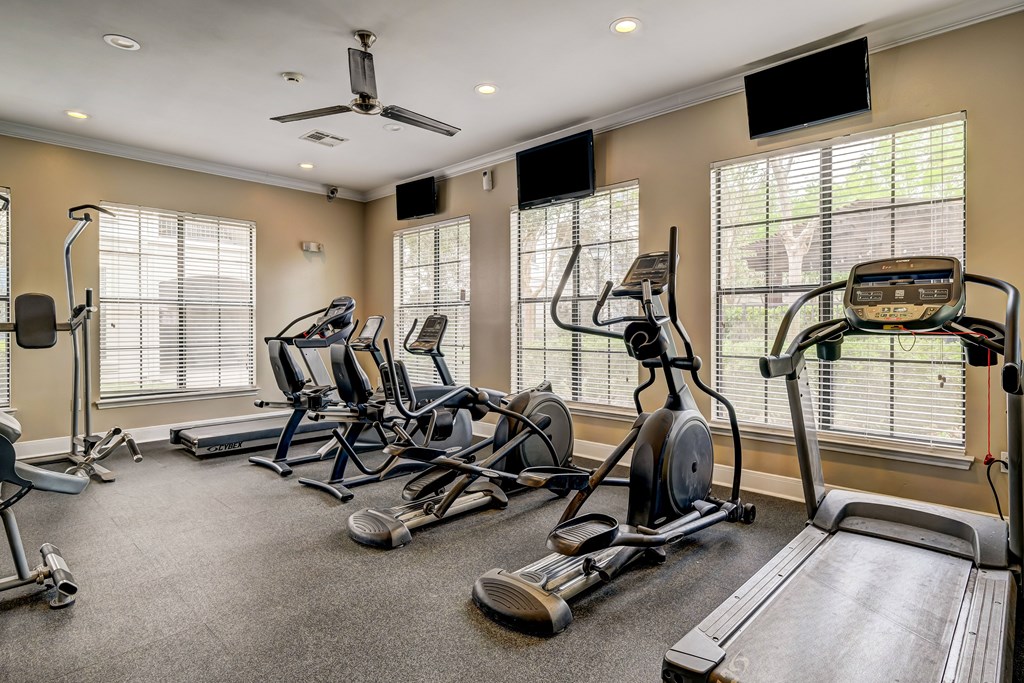 A spacious home gym with a variety of exercise equipment.